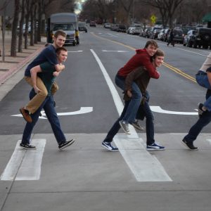 Members of the band The Party Boys of America crossing a street