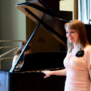 Vanessa Doss sings at the piano in the Organ Recital Hall