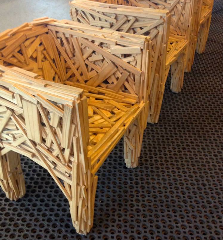 wooden chairs pieced together with wood the size of rulers