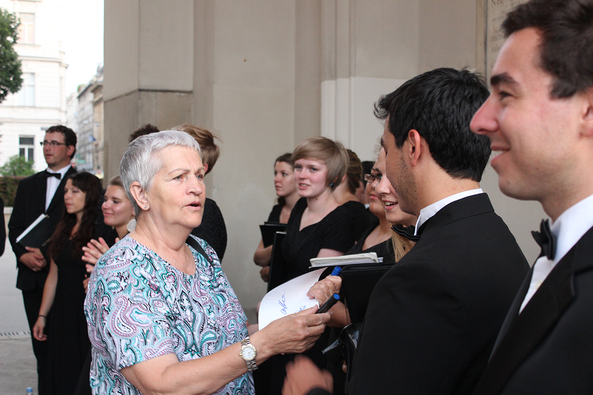 Schyler Vargas signing a program during 2015 Chamber Choir Tour photo