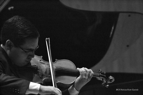 Frangel Lopez Cesena pictured playing the violin