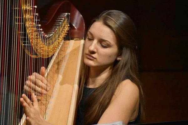 Student pictured playing Harp