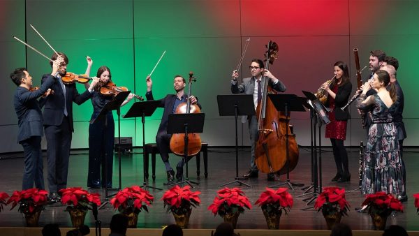 Frisson pictured on stage with their instruments and poinsettias.