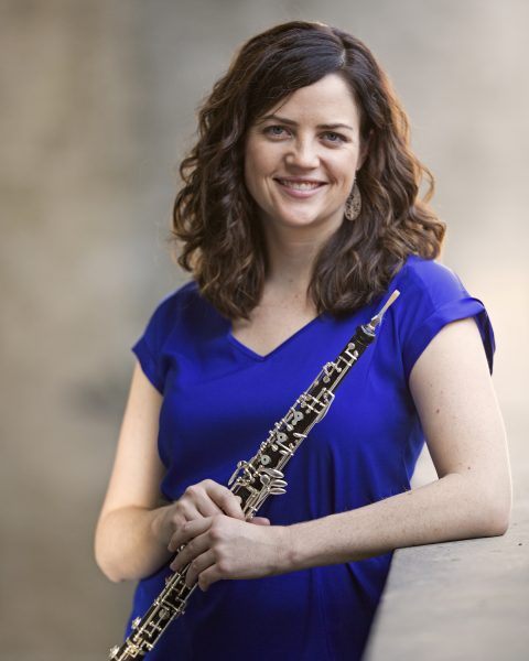 2025 Guest Artist Jennifer Cullinan pictured in blue shirt with oboe