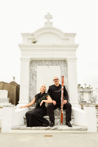 2025 Guest Artists Takin' Souls Duo pictured in front of a large white headstone.